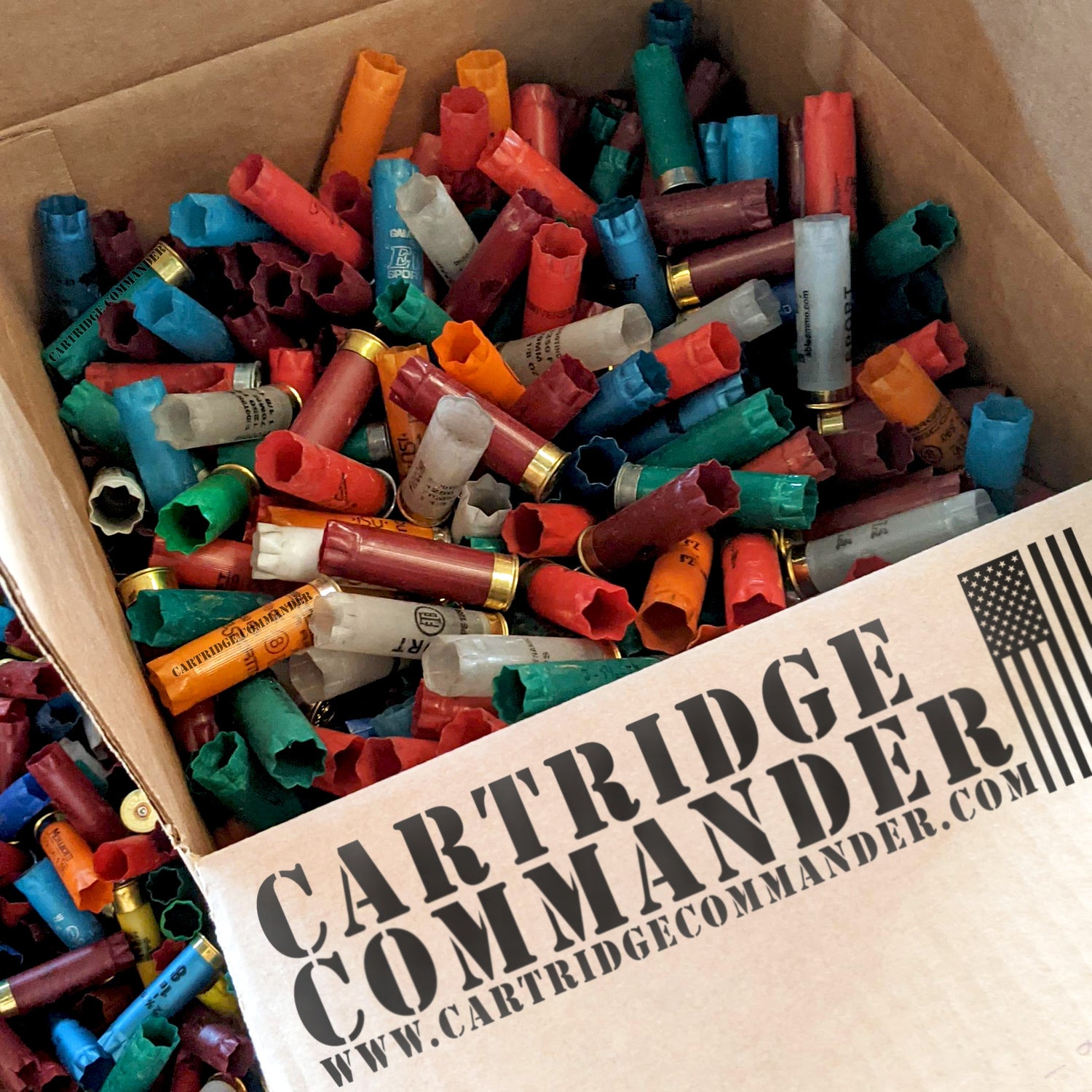 Box of empty 12 gauge shotgun shells / hulls, mixed colors